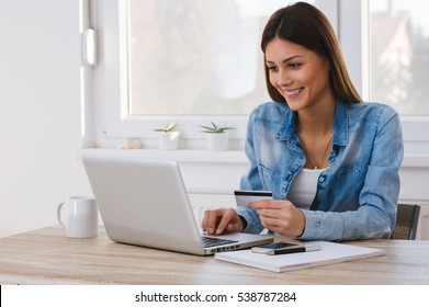 Shot of a women holding a credit card and purchasing online