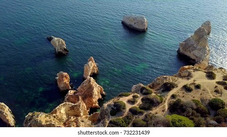 Shot of wonderful view taken with drone and showing picturesque landscape of tropical coastline with rocks and green, Portugal, Algarve.