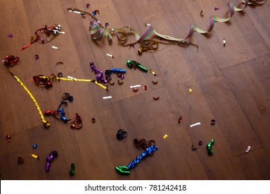 Shot Of A Wooden Floor After A Party Celebration With Party Poppers And Confetti 