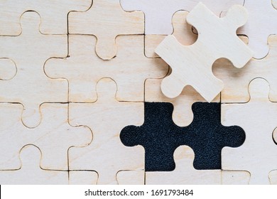 Shot of wooden jigsaw puzzle pieces on black background,Business concept - Shutterstock ID 1691793484