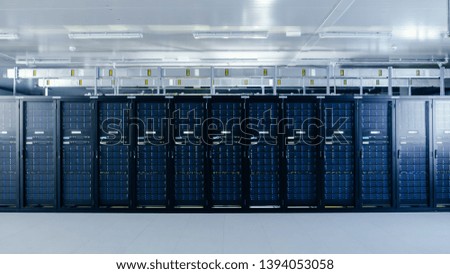 Shot of a Working Data Center With Rows of Rack Servers. Led Lights Blinking and Computers are Working.