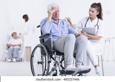 Shot of a worried senior man on a wheelchair and a doctor talking to him - Powered by Shutterstock