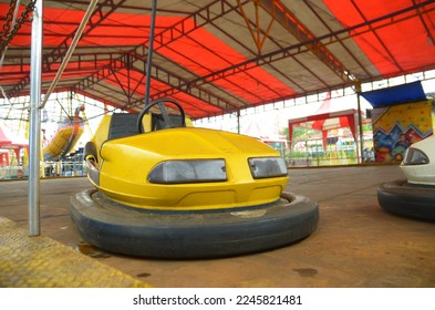 A shot of a yellow bumber car at a fair