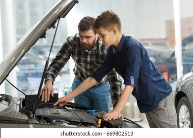 Shot of a young boy talking to his cheerful father sitting together in a new car driving travelling trip journey happiness lifestyle parent vehicle automobile rent safety insurance family parenting  - Powered by Shutterstock