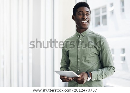 Shot of a young businessman using a digital tablet in an office