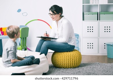 Shot of a young child psychologist talking with a boy