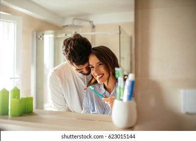 Shot of young couple bonding during daily morning routine in bathroom. - Powered by Shutterstock