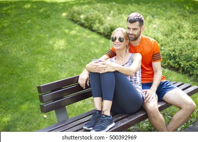 Shot of a young couple relaxing after running outdoor. - Powered by Shutterstock