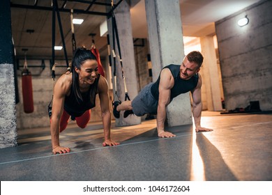 Shot Of A Young Couple Working Out At The Gym