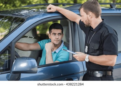 Shot Of A Young Driver Talking To A Traffic Policeman