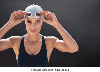 Shot Of A Young Female Swimmer Isolated On Black Background. Fit Young Woman In Swimming Costume With Copy Space.