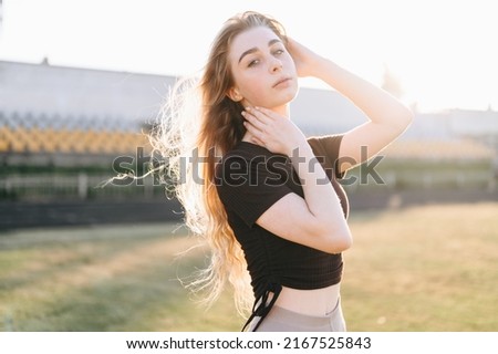 Similar – young girl standing near old building with wires