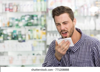 Shot Of A Young Handsome Bearded Man Coughing Shopping At The Local Drugstore For Medicine Flu Cold Sick Sickness Disease Bronchitis Medicine Cure Vitamins Immune Health Help Exhausting.