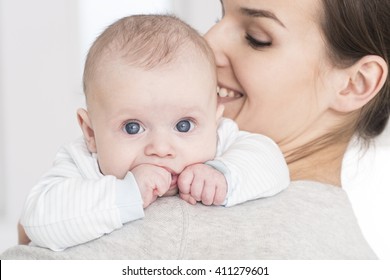 Shot of a young happy mother holding her baby