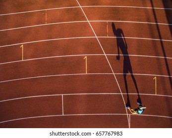 Shot of a young male athlete training on a race track. Sprinter running on athletics tracks. - Shutterstock ID 657767983