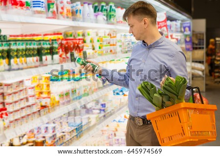 Shot of a young man checking a certain product while shopping food at the supermarket copyspace consumer consumerism buying shopping shopper buyer people lifestyle grocery living concept