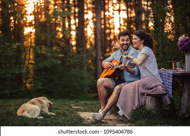 Shot Of A Young Man Couple Singing Together On A Picnic