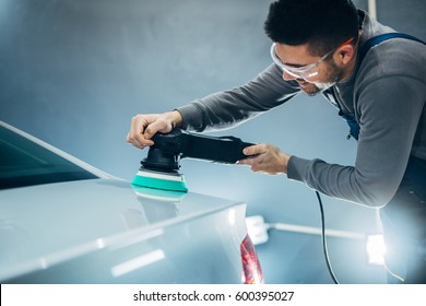 Shot Of A Young Man Polishing His Car.