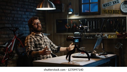 Shot Of Young Man Talking On Camera In A Workshop Making Video Blog