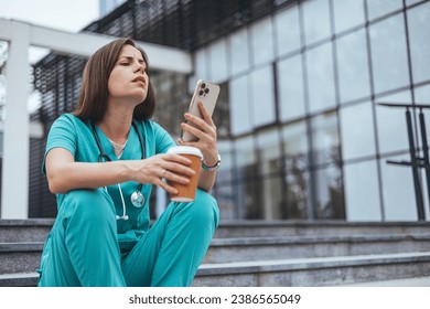 Shot of a young medical practitioner looking stressed out in a hospital.  Exhausted sad doctor feels burnout stress. Worried nurse sitting on floor.  - Powered by Shutterstock