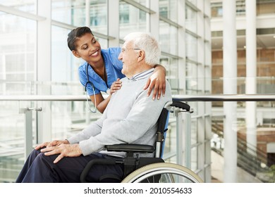 Shot Of A Young Nurse Caring For An Elderly Patient In A Wheelchair