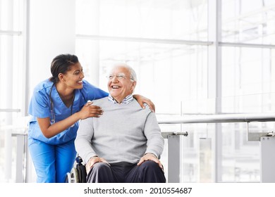Shot of a young nurse caring for an elderly patient in a wheelchair - Shutterstock ID 2010554687