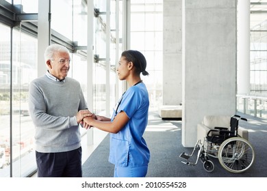 Shot Of A Young Nurse Holding Hands With An Elderly Patient