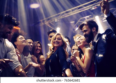 Shot of a young woman dancing with friends