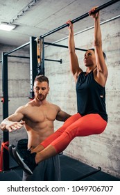 Shot Of A Young Woman Doing Leg Raises On A Pull Up Bar