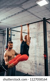 Shot Of A Young Woman Doing Leg Raises On A Pull Up Bar