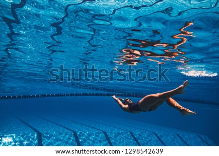 Shot of a young woman in the pool