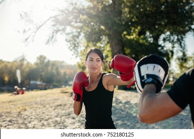 Shot of a young woman practicing boxing - Powered by Shutterstock