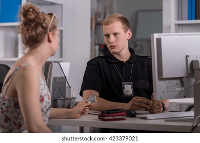 Shot Of A Young Woman Reporting A Crime To A Young Policeman