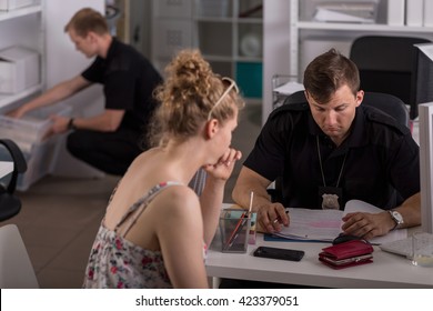 Shot Of A Young Woman Talking To A Policeman At A Police Station