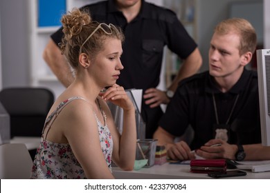 Shot Of A Young Woman Talking To Two Policemen At A Police Station