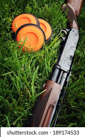 Shotgun And Clay Pigeons