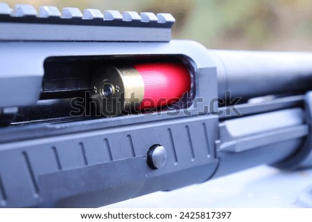 shotgun side view A shotgun shell is being loaded