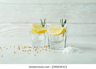 Shots of tequila on white textured table