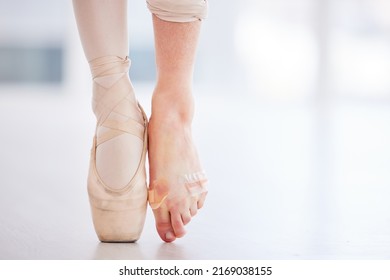 I should definitely tape my feet more often. Cropped shot of a young ballerina wearing a pointe shoe on one foot and band aids on her barefoot.