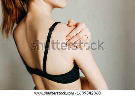 Shoulder and joint injuries, and fatigue at work. The zone of injury, the image on a blank background. A spasm on the girl's shoulder. 