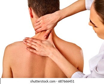 Shoulder and neck massage for man in spa salon. Doctor making neck therapy in rehabilitation center. Folded towels in the background. Correction of dislocation of the neck. - Powered by Shutterstock