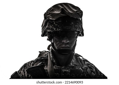 Shoulder portrait of modern army infantry soldier with dirty face in digital camouflage battle uniform, combat helmet, tactical sunglasses looking at camera desaturated, isolated on white background