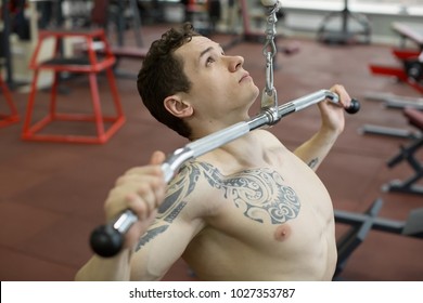 
Shoulder Pull Down Machine. Fitness Man Working Out Lat Pulldown Training At Gym. Upper Body Strength Exercise For The Upper Back.