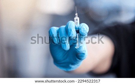 I shouldnt be forced into this. Shot of a man holding a syringe with the covid vaccine.