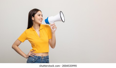 Shout out loud with megaphone. Young beautiful asian woman woman announces with a voice about promotions and advertisements for products at a discounted price. Shopping and fashion concept. - Shutterstock ID 2004533990