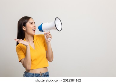 Shout out loud with megaphone. Young beautiful asian woman woman announces with a voice about promotions and advertisements for products at a discounted price. Shopping and fashion concept. - Shutterstock ID 2012384162