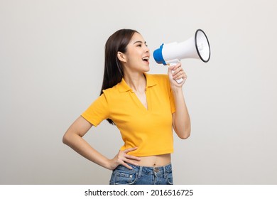 Shout out loud with megaphone. Young beautiful asian woman woman announces with a voice about promotions and advertisements for products at a discounted price. Shopping and fashion concept. - Shutterstock ID 2016516725