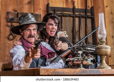 A Shouting Cowboy And Saloon Girl Point Their Weapons At You