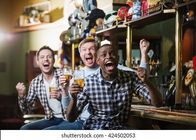 Shouting Fans With A Beer At A Bar