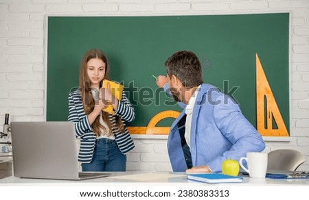 shouting school teacher with selective focus of child at blackboard